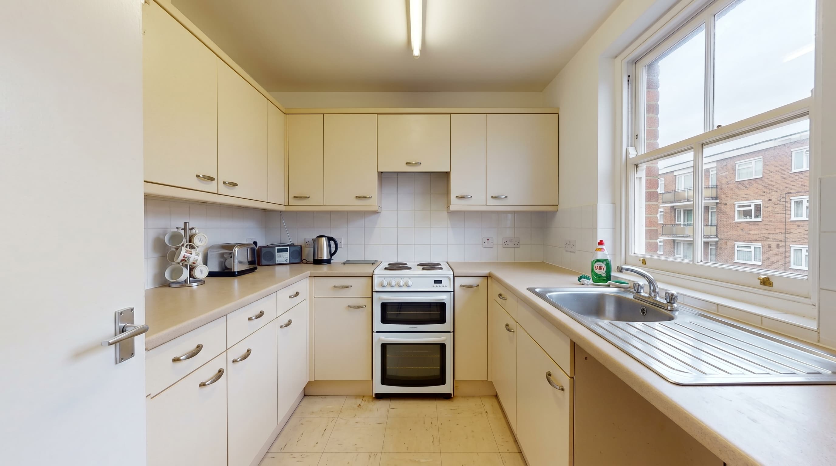 Before: outdated kitchen in a Chelsea apartment before bespoke renovation by ERCO Home Improvements London